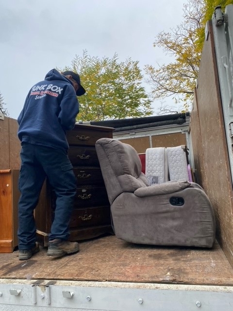 Feller loading furniture into truck